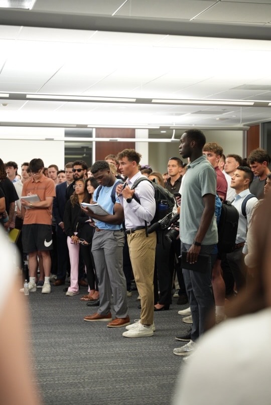 Producers packed into a training hallway
